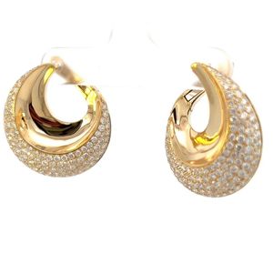 Gold hoop earrings with pave set diamonds on a white background
